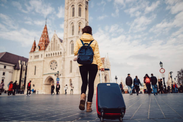 young woman with suitcase at the castle hill budapest
